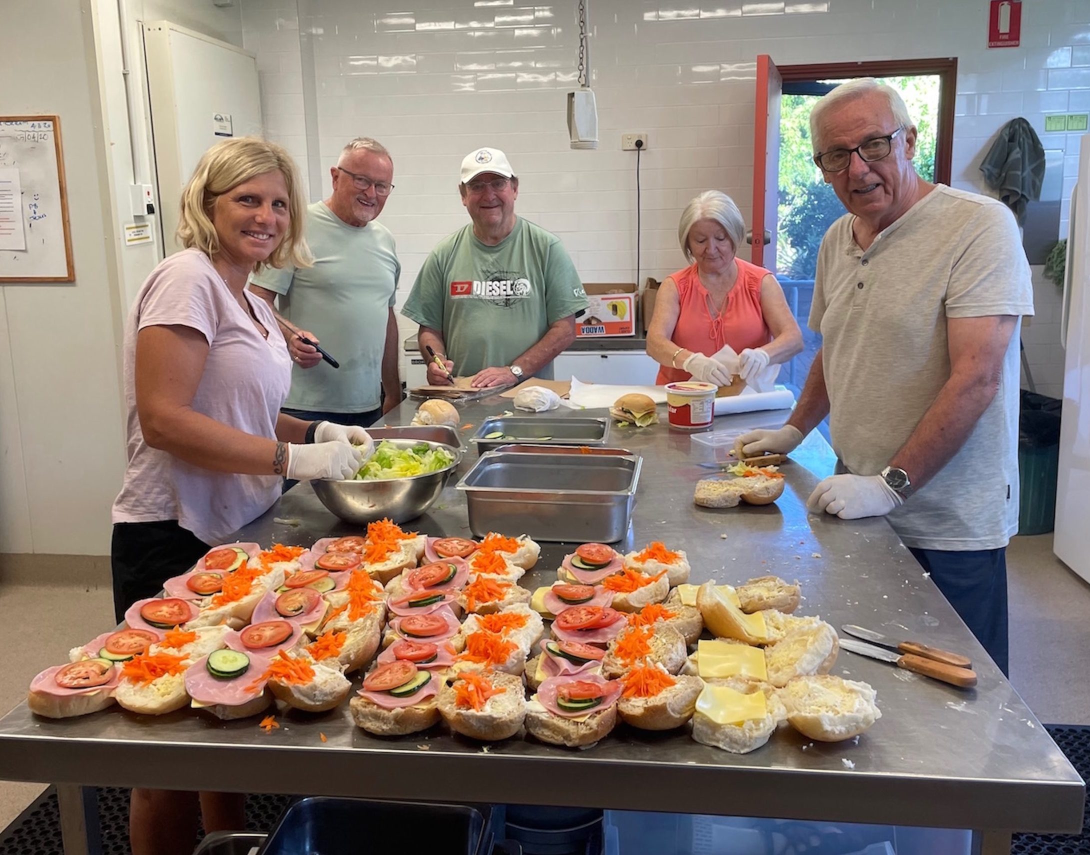 Volunteers preparing bread rolls for lunch